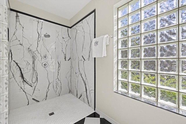 bathroom with tiled shower