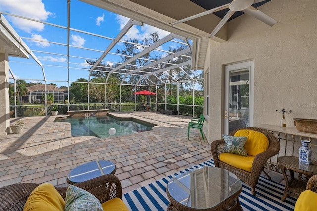 view of swimming pool featuring a lanai, ceiling fan, and a patio area