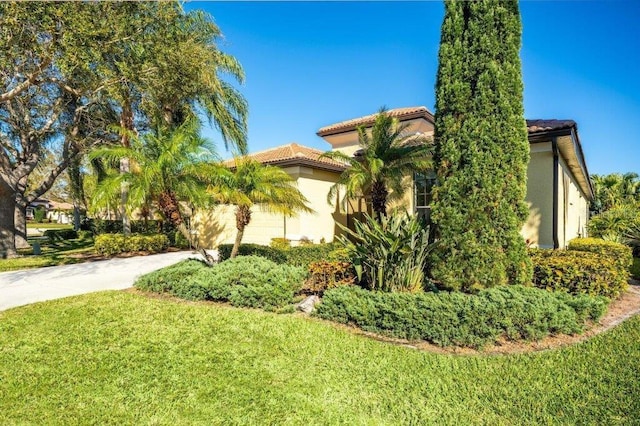 view of property exterior featuring a lawn