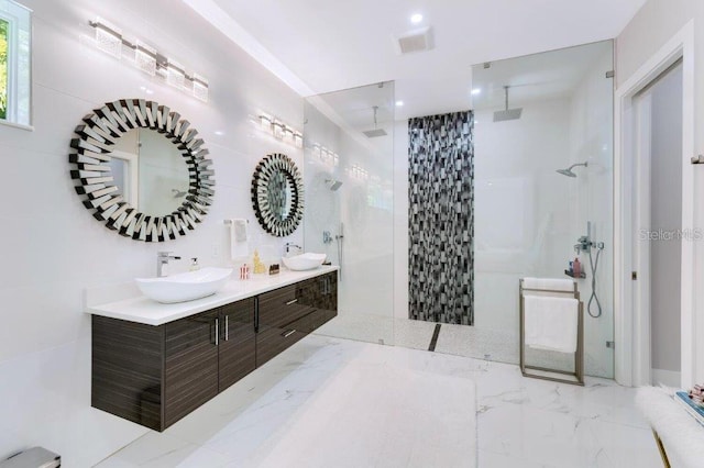 bathroom featuring vanity and tiled shower