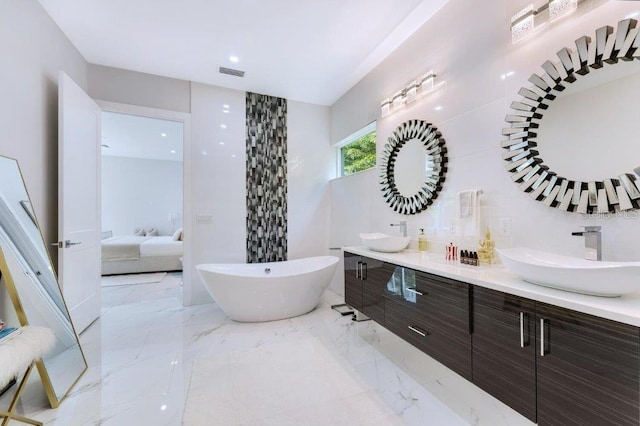 bathroom with vanity and a tub