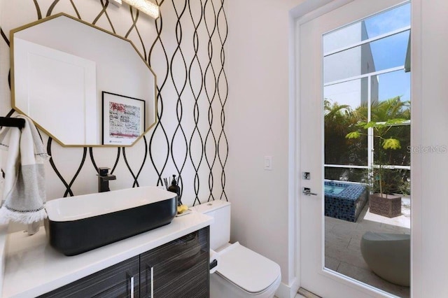 bathroom featuring vanity and toilet