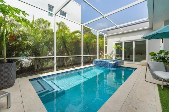 view of pool featuring an in ground hot tub, a patio area, and glass enclosure