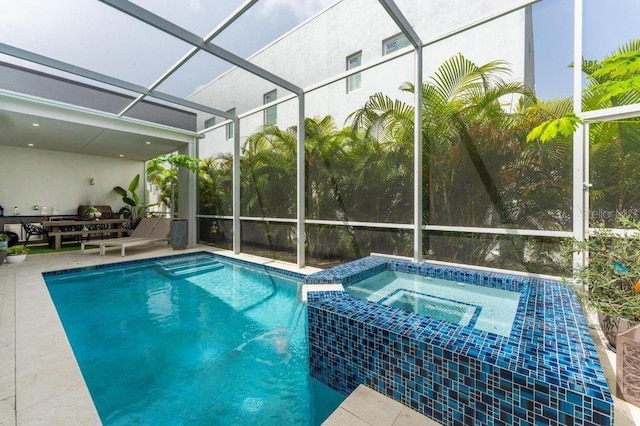 view of swimming pool featuring an in ground hot tub, a patio, and glass enclosure