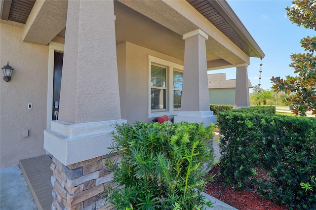 view of home's exterior featuring covered porch and stucco siding