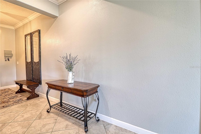 hallway featuring crown molding, baseboards, and light tile patterned floors