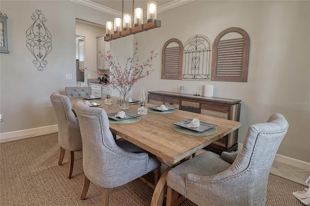 dining area with light tile patterned floors, baseboards, crown molding, and an inviting chandelier