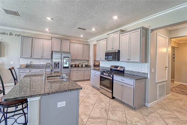 kitchen with gray cabinets, visible vents, and stainless steel appliances