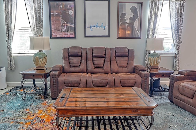 living room featuring a wealth of natural light and baseboards