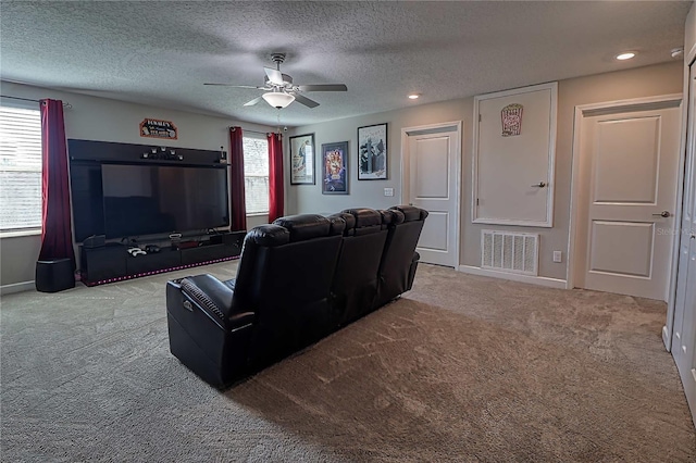 carpeted home theater with baseboards, visible vents, ceiling fan, a textured ceiling, and recessed lighting