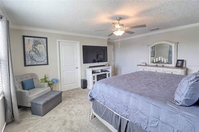 carpeted bedroom featuring ceiling fan, visible vents, a textured ceiling, and ornamental molding