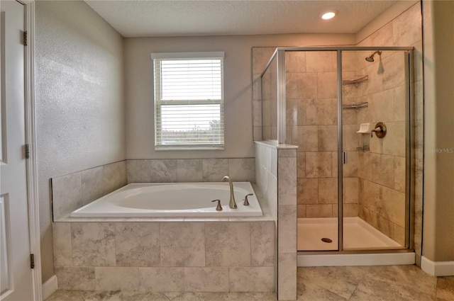 bathroom featuring a textured ceiling, tile patterned flooring, a shower stall, and a bath