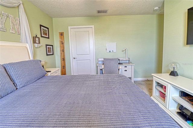 carpeted bedroom with a textured ceiling, visible vents, and baseboards