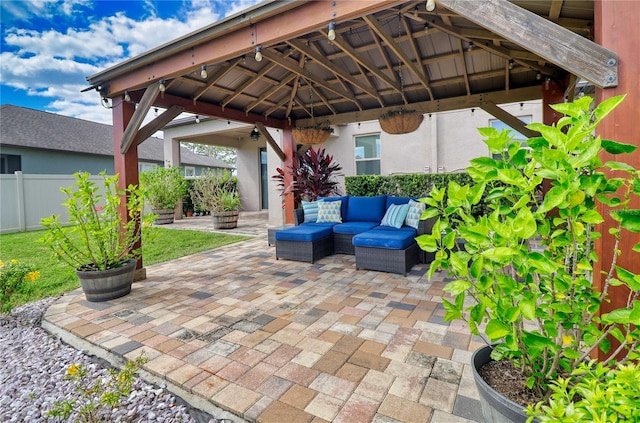 view of patio / terrace with an outdoor hangout area, a gazebo, and fence