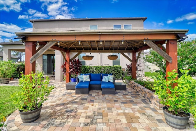 view of patio with an outdoor living space and a gazebo