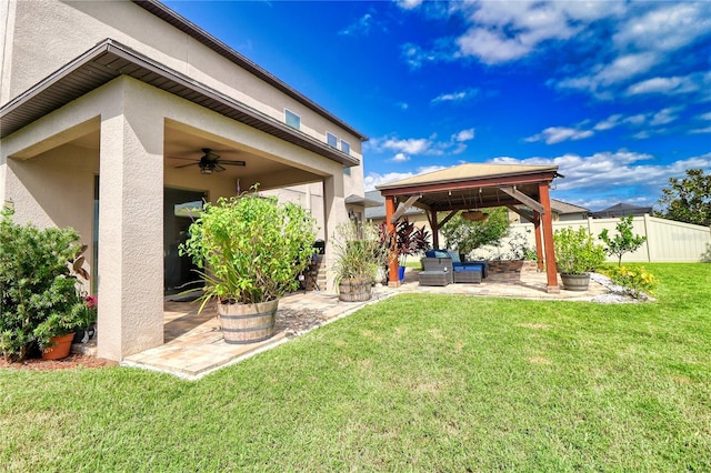 view of yard with a patio area, ceiling fan, fence, and a gazebo