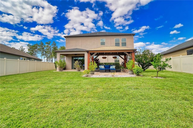 rear view of house with a patio, a fenced backyard, a yard, an outdoor living space, and stucco siding