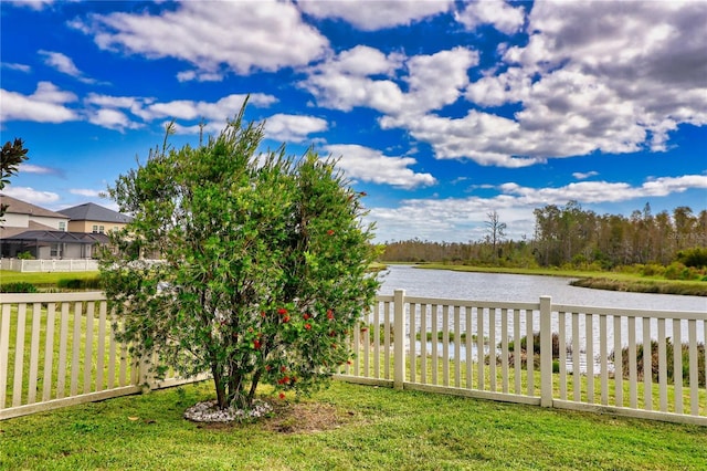 view of yard with a water view and fence