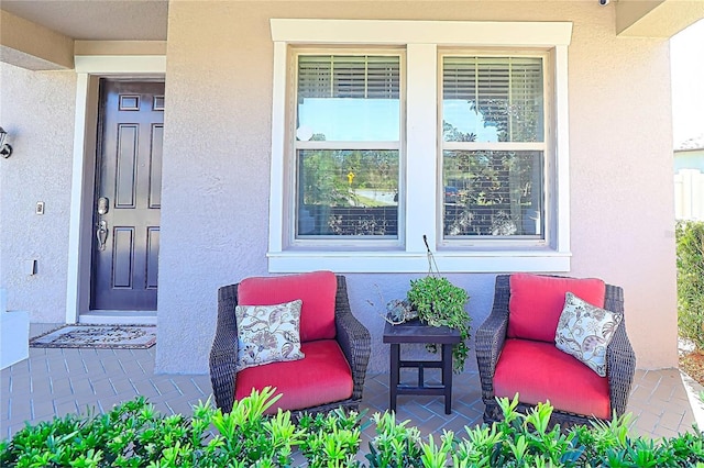 entrance to property featuring stucco siding