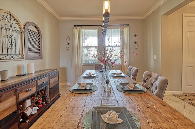 dining room featuring baseboards, ornamental molding, and tile patterned floors