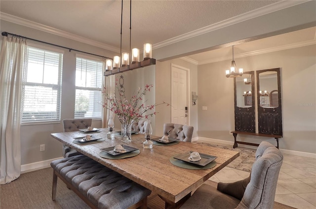 dining room with light tile patterned floors, ornamental molding, a textured ceiling, and baseboards