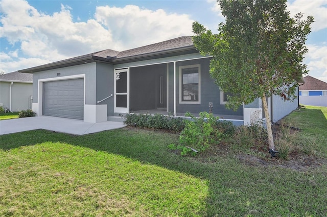 view of front of home featuring a garage and a front lawn