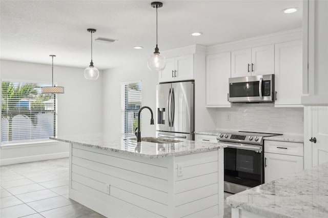 kitchen with white cabinets, stainless steel appliances, and a healthy amount of sunlight