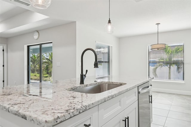 kitchen with sink, dishwasher, white cabinets, hanging light fixtures, and light tile patterned flooring