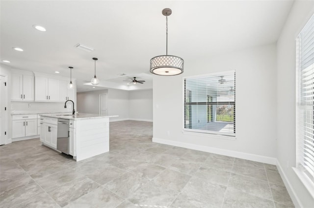 kitchen with ceiling fan, pendant lighting, dishwasher, white cabinetry, and an island with sink