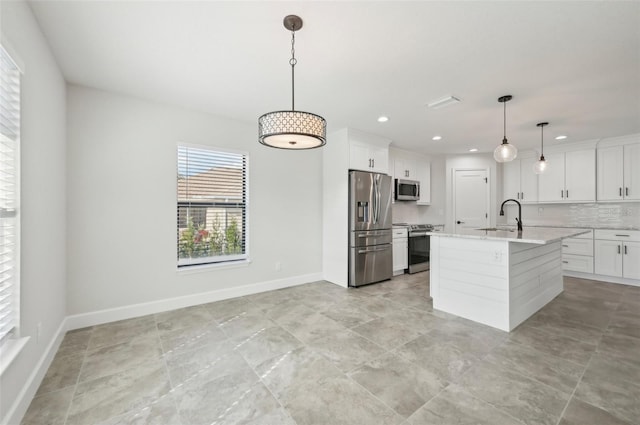 kitchen featuring a center island with sink, sink, hanging light fixtures, white cabinetry, and stainless steel appliances