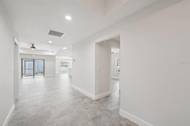 hall featuring light tile patterned floors