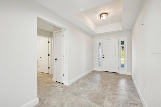 foyer with a raised ceiling