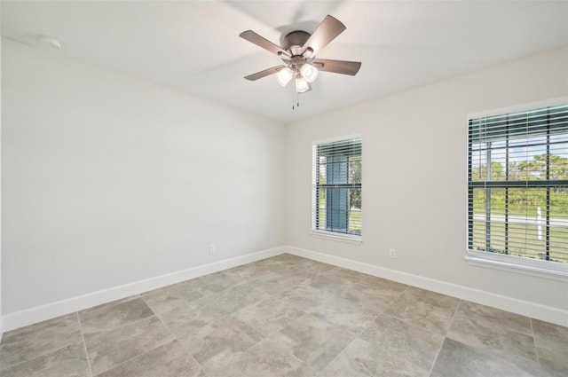 empty room featuring ceiling fan and a healthy amount of sunlight