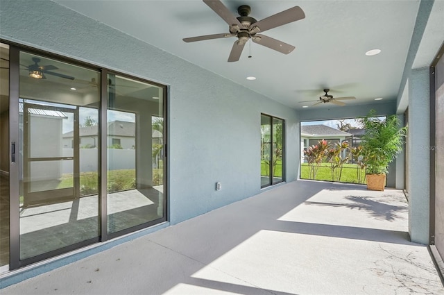 sunroom / solarium featuring ceiling fan