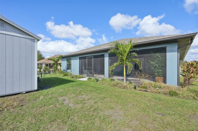 back of property with a sunroom and a yard