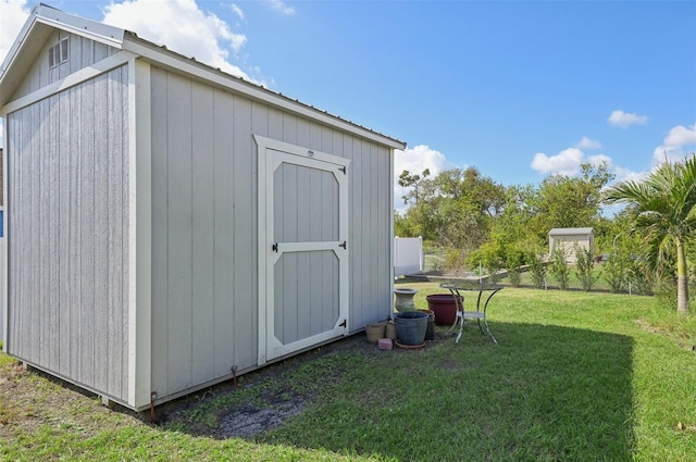 view of outbuilding featuring a lawn