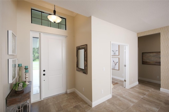 foyer entrance with a textured ceiling