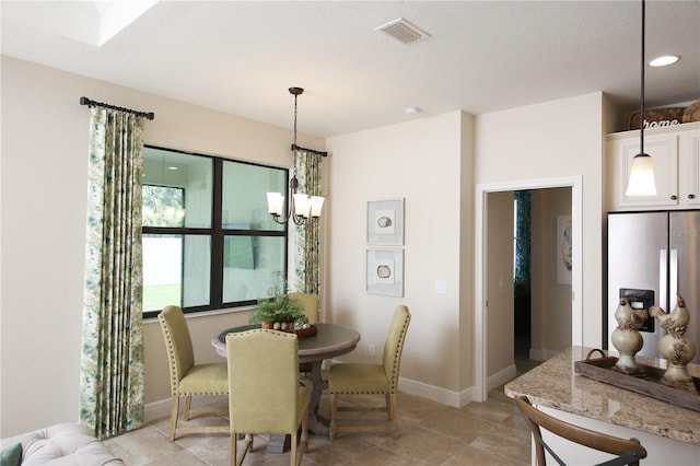 dining area with a notable chandelier