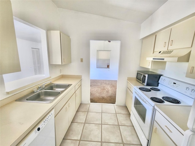 kitchen featuring cream cabinets, sink, light tile patterned floors, and white appliances