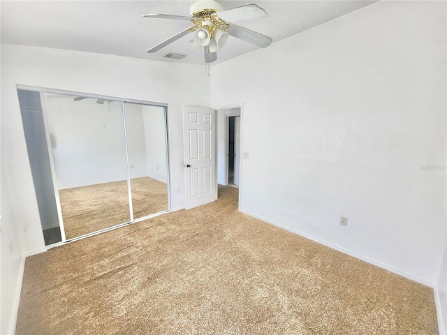 unfurnished bedroom with a closet, carpet flooring, and ceiling fan