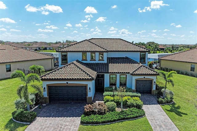 mediterranean / spanish home featuring a garage and a front lawn