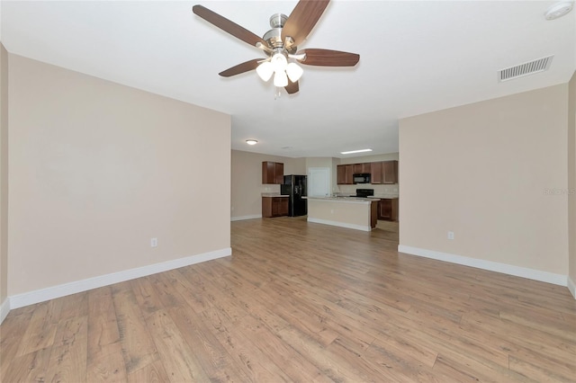 unfurnished living room with light hardwood / wood-style flooring and ceiling fan