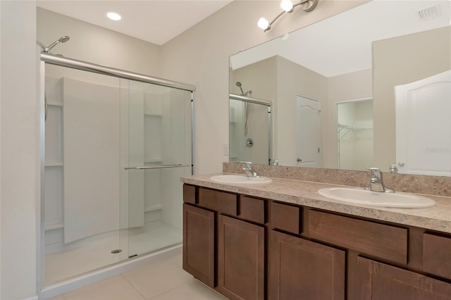 bathroom featuring vanity, an enclosed shower, and tile patterned flooring