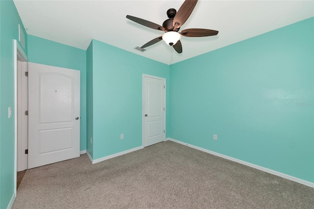 unfurnished bedroom featuring light colored carpet and ceiling fan