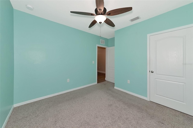 unfurnished bedroom featuring light colored carpet and ceiling fan