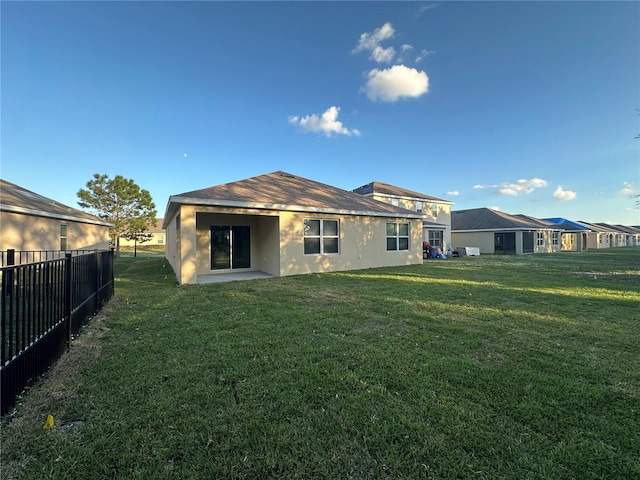 rear view of house with a lawn