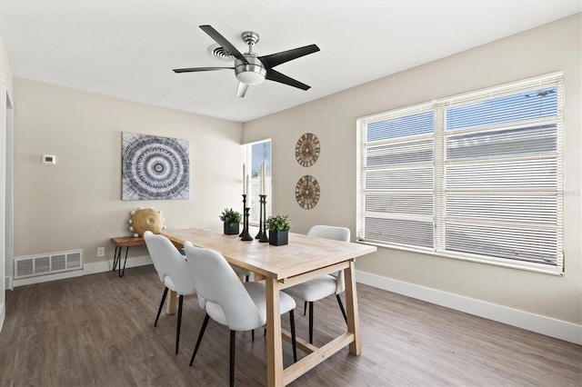 dining area featuring dark wood-type flooring and ceiling fan