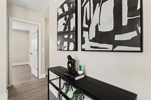 hall with wood finished floors and baseboards