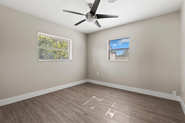 spare room with wood finished floors, baseboards, and ceiling fan
