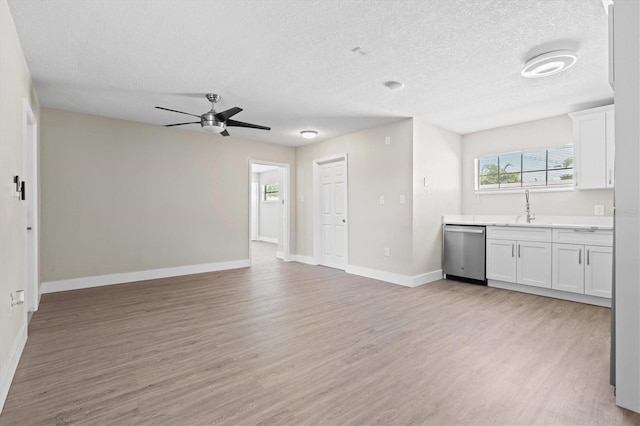 unfurnished living room featuring light hardwood / wood-style floors and a textured ceiling